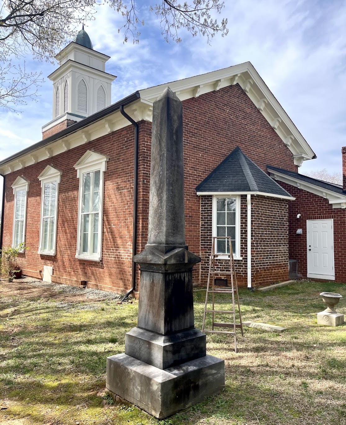 Historic obelisk monument beside the church